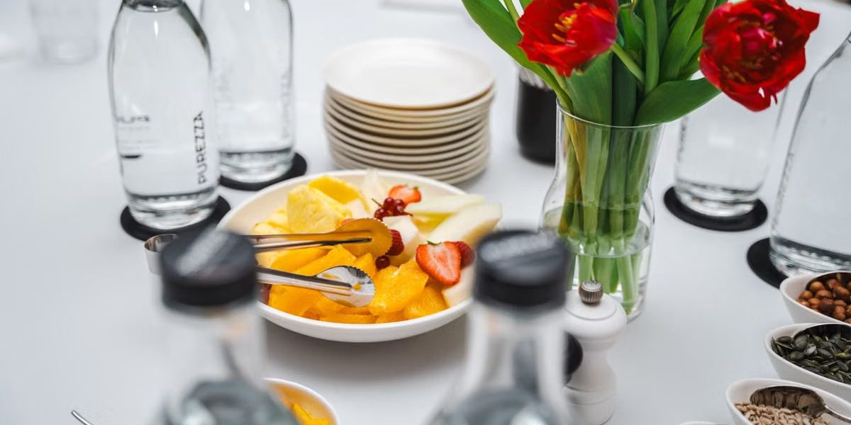 An elegant dining setup featuring fresh fruits and vibrant tulips, perfect for a healthy meal.