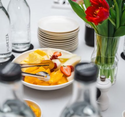 An elegant dining setup featuring fresh fruits and vibrant tulips, perfect for a healthy meal.